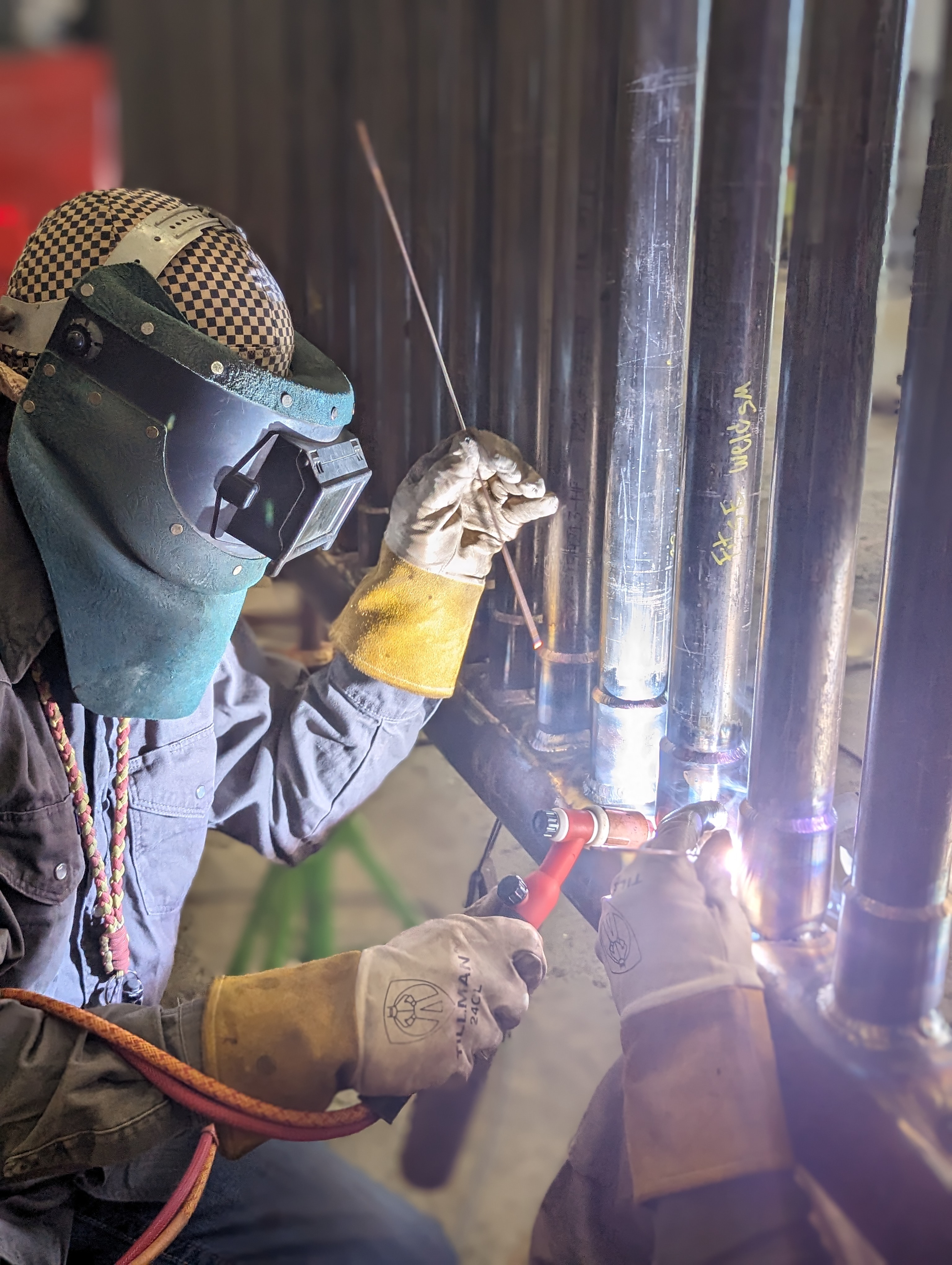 Viking Vessel Services welder fabricating tube connections in the shop