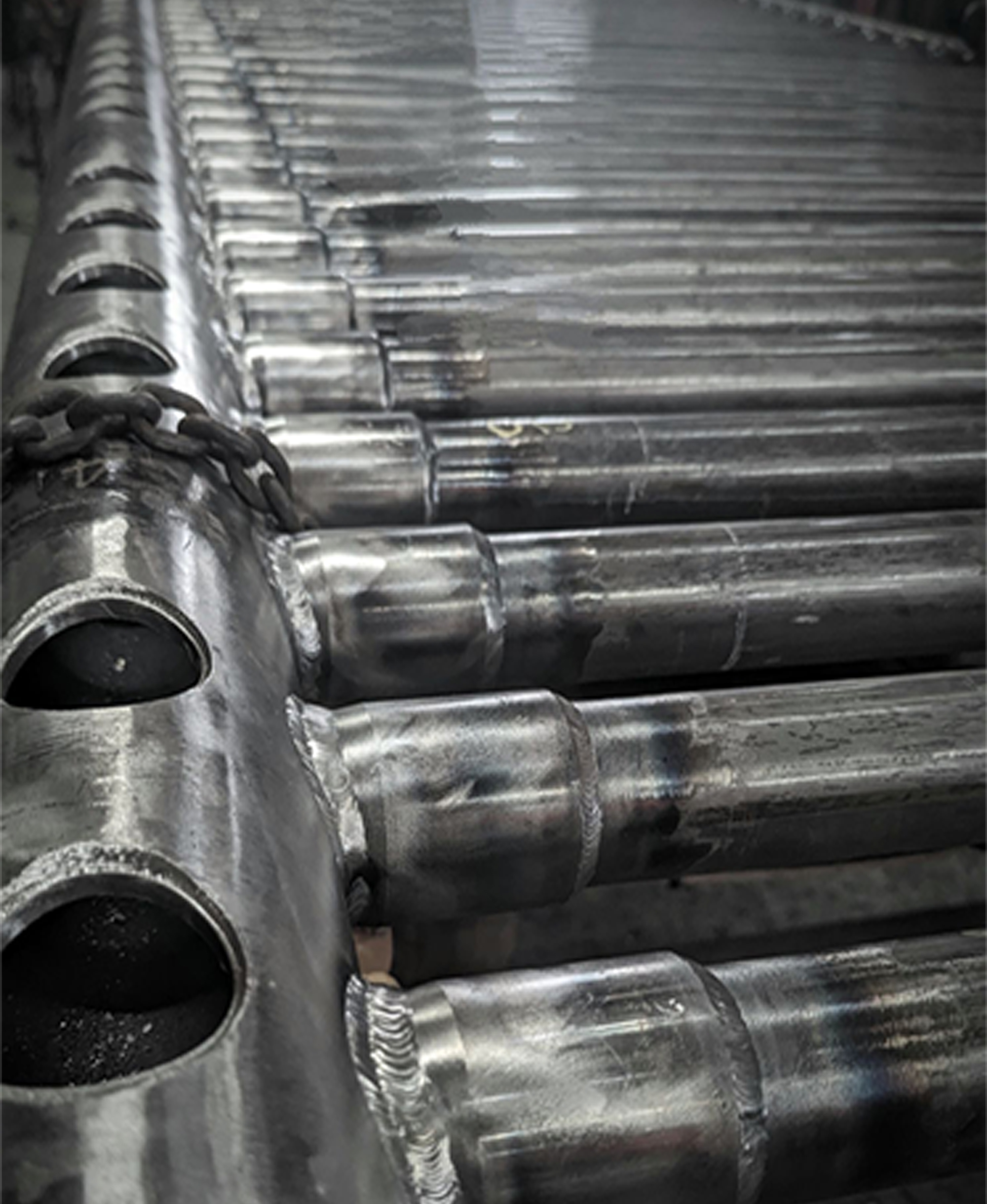TTT-lined header assembly with engineered tube connections