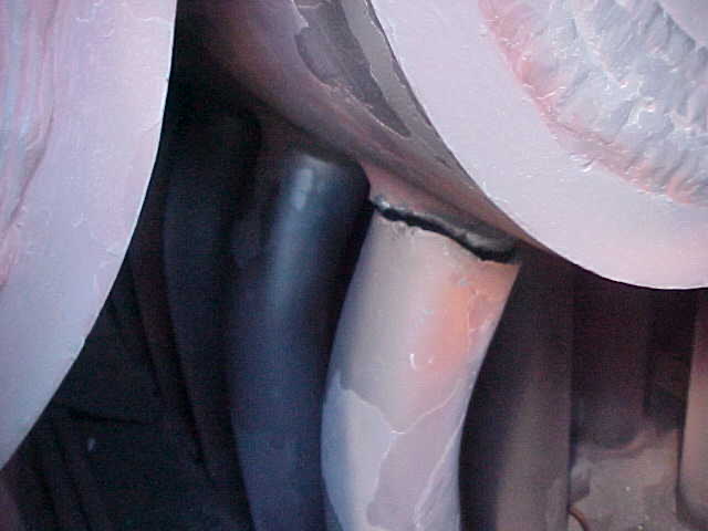 Close-up of a cracked boiler tube in an HRSG header