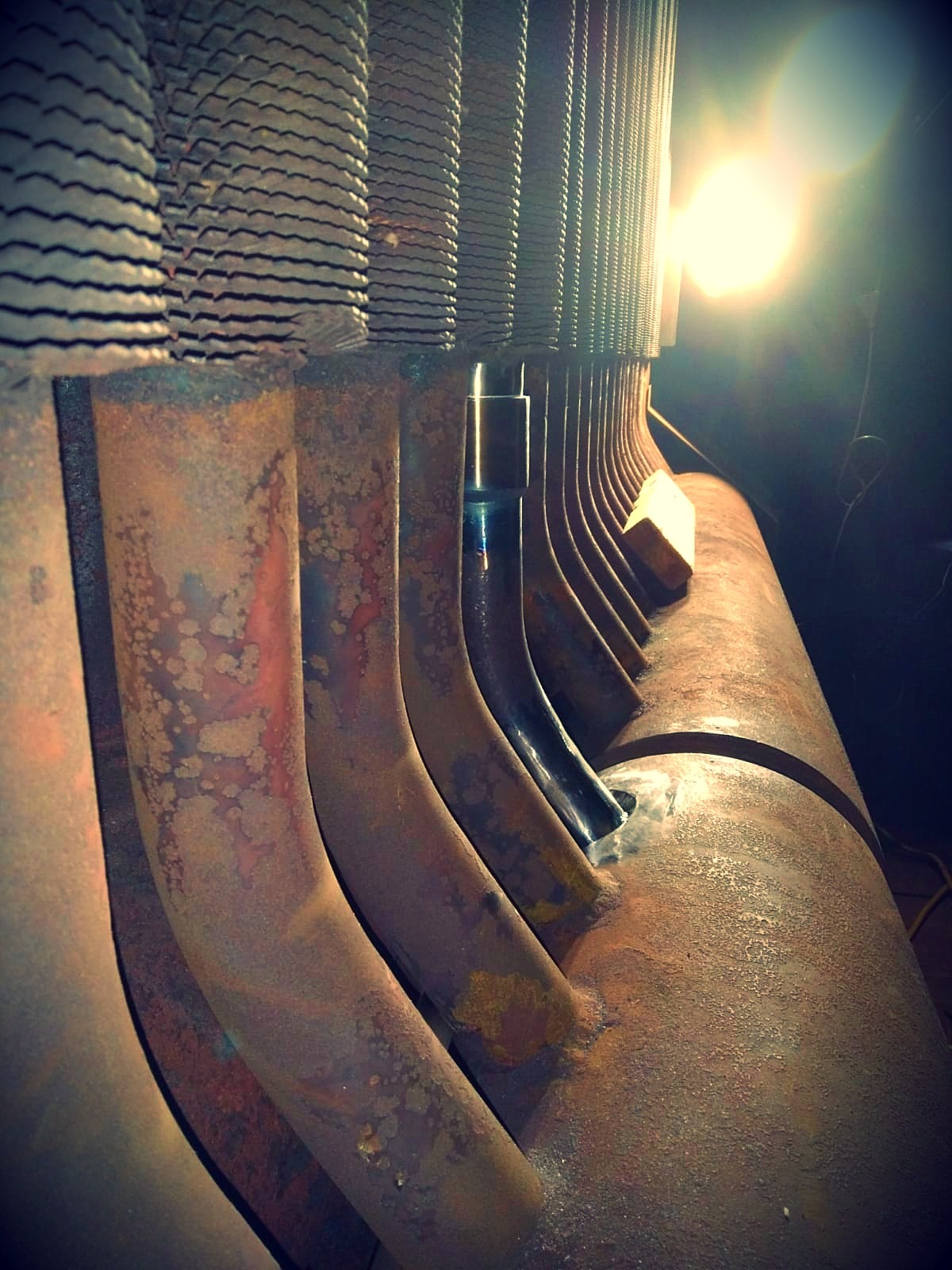 Rows of corroded HRSG tubes at a header